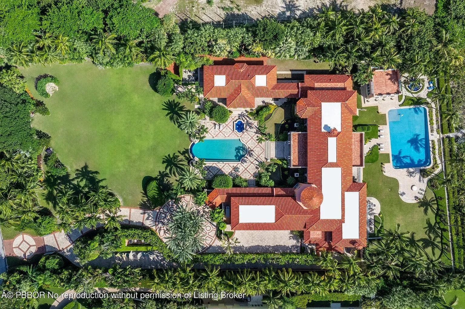 Aerial shot. acres of palms, paths, and those terracotta roofs everywhere.