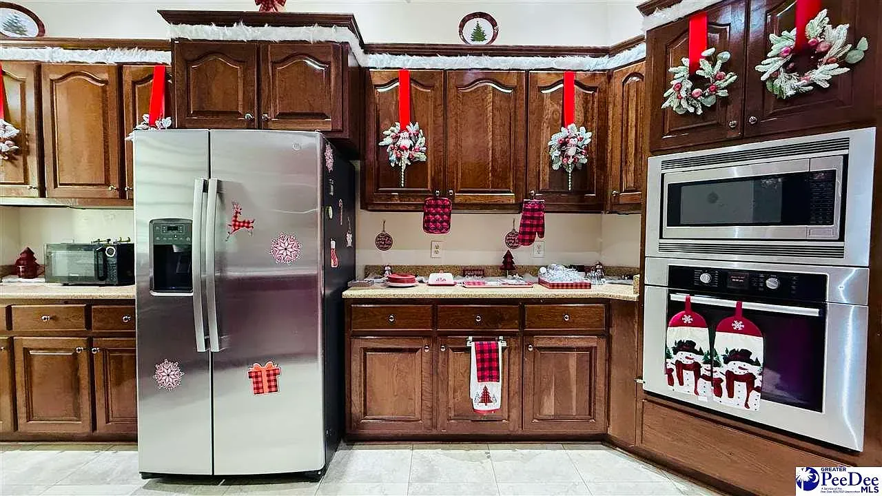 Holiday kitchen vibes. Dark wood everywhere and the stainless fridge pops.