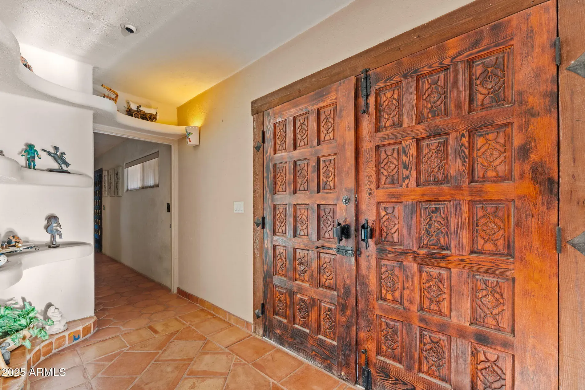 These carved double doors go hard. Iron hardware is perfect.