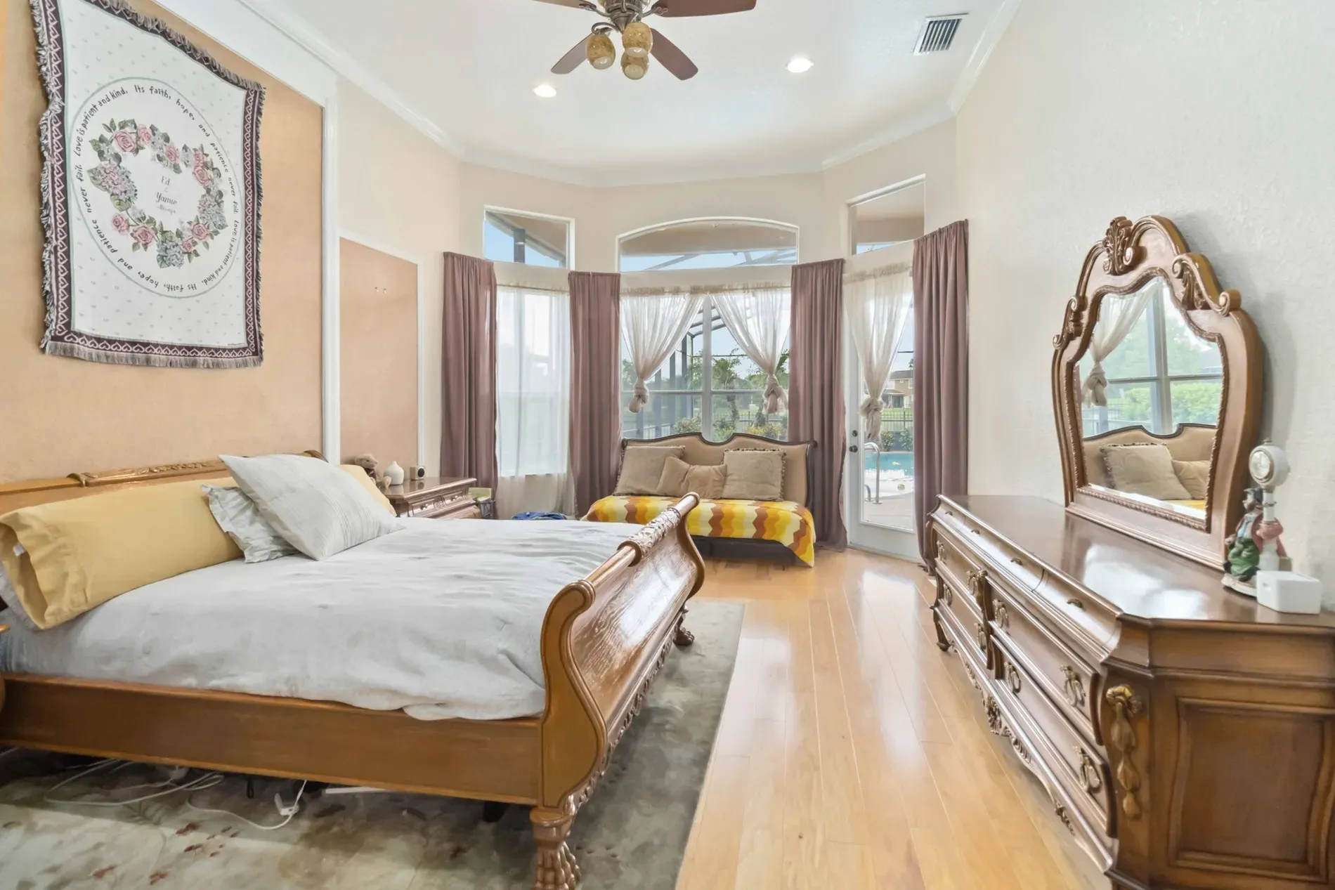 King bed with carved dark wood—feels luxe hotel but warmer.