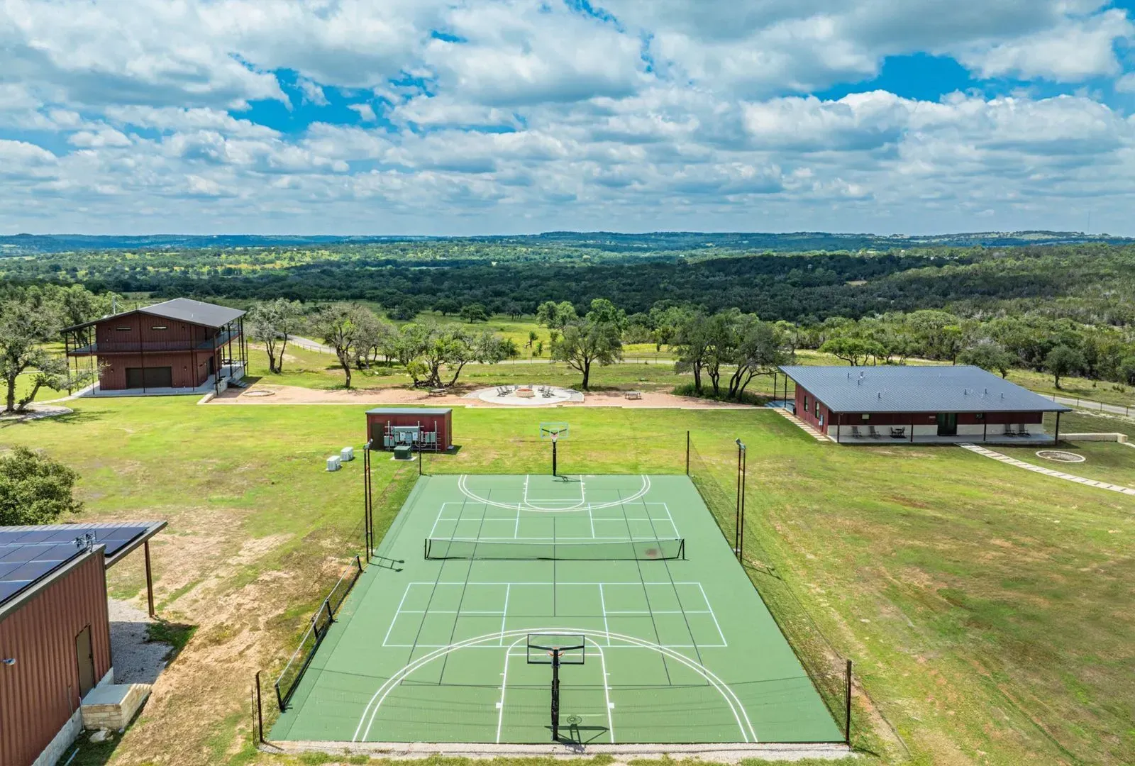 Multi-sport court out of nowhere. Basketball? Tennis? Paging the neighborhood tournament.