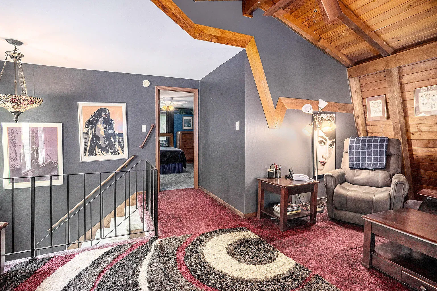 Loft vibes with those beams. Feels a cabin treehouse.