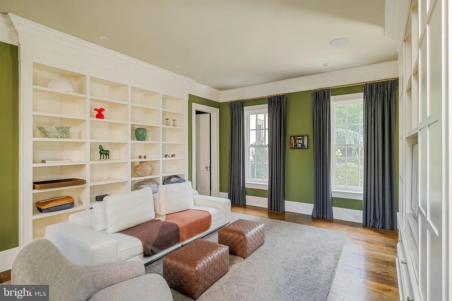 Earthy green walls, blue curtains framing that view. Cozy without trying.