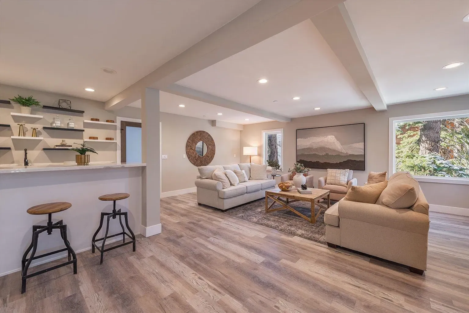 Big beige sectional around a large round table. Cozy hangout spot.