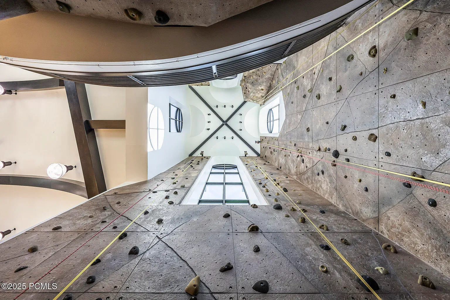 Climbing wall looks legit. Earthy holds, big volume. Helmet hair incoming.