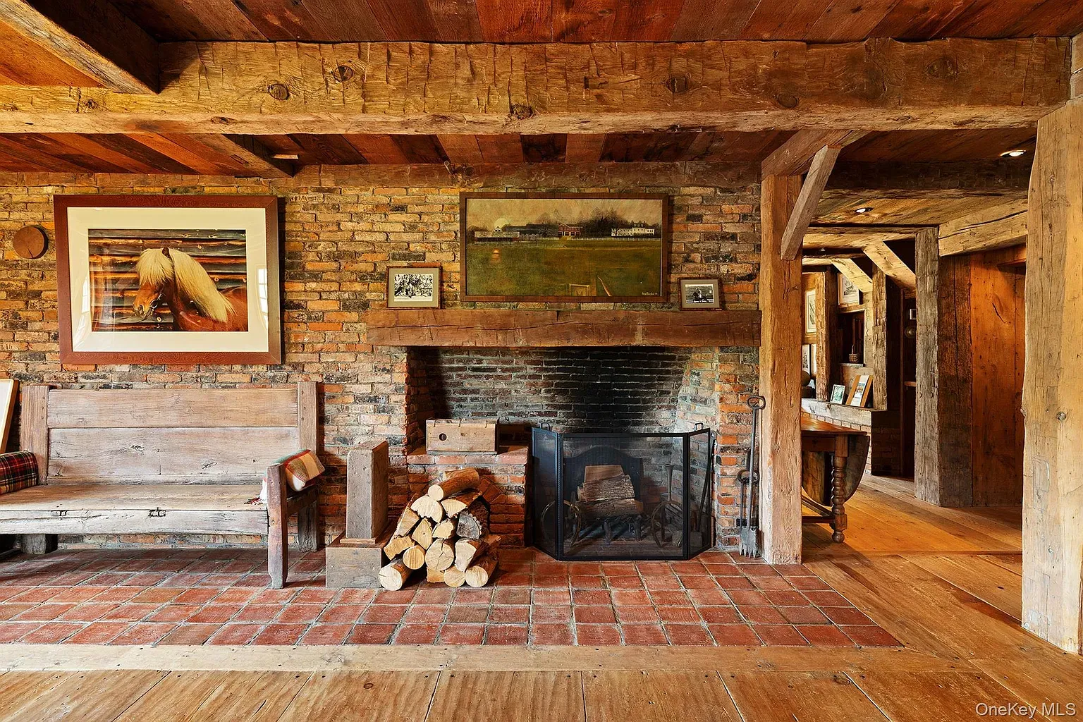 Okay, this fireplace goes hard. Stacked logs and a big moody art moment.