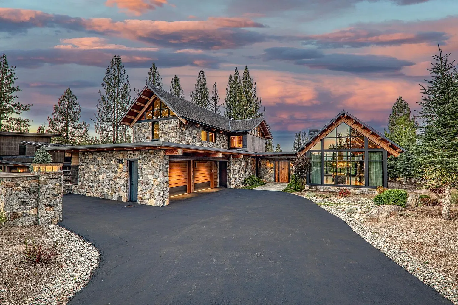 Stone and glass mountain front. Angular rooflines look sharp against the pines.