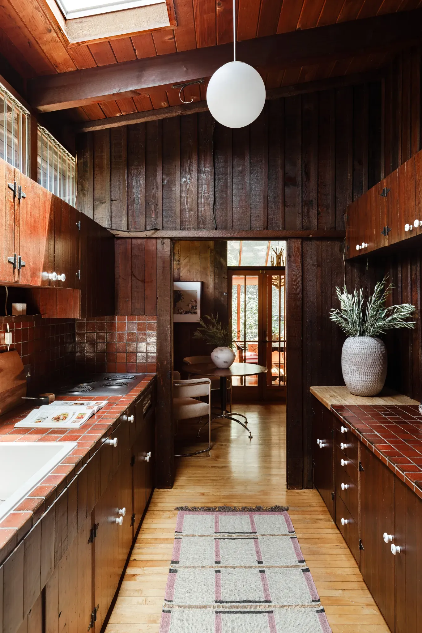 Love the dark wood kitchen. Those beams make it feel a cabin.