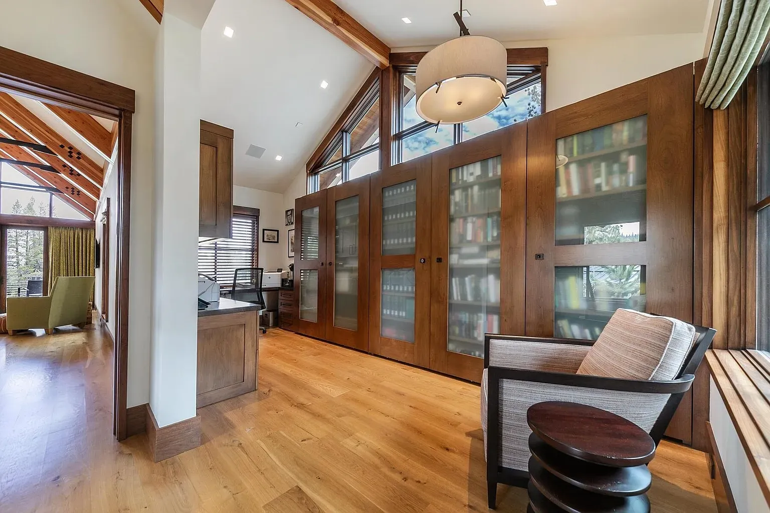 Sloped ceiling moment. Those beams plus the huge window wall feel cozy and open.