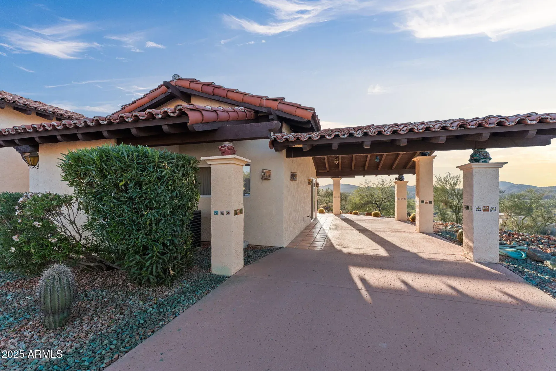 Front entry with the clay tile roof and stucco. Plants actually thriving.