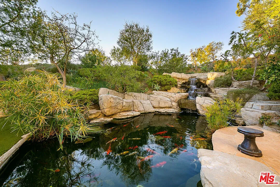 Back to the koi pond. Stone edges, glassy water. From above, zen.
