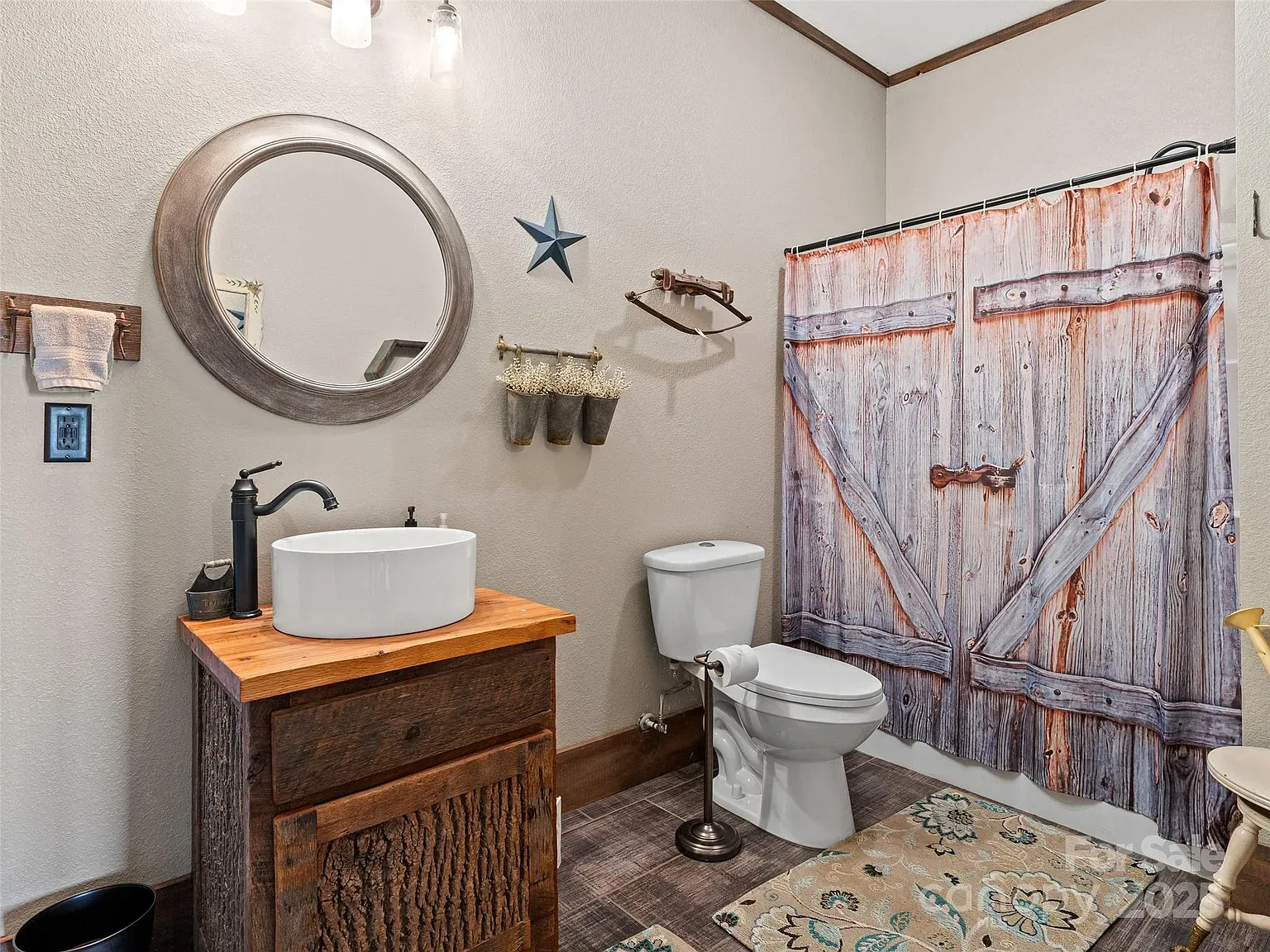 Distressed wood vanity plus round vessel sink. Rustic meets hotel bathroom.