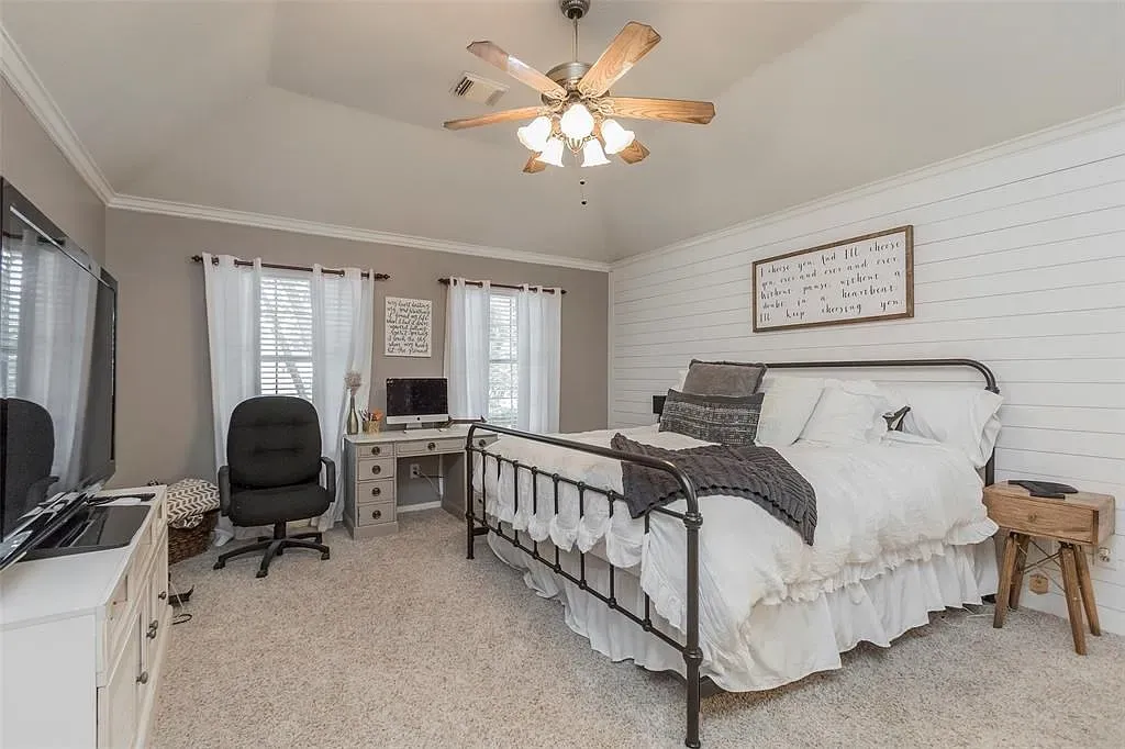 Wrought-iron bed, white bedding, soft carpet. Cozy meets rustic without trying too hard.