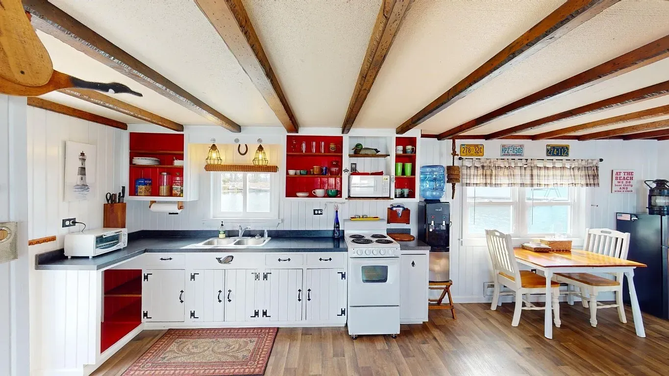 The beams make this little kitchen feel warm. White walls keep it bright.