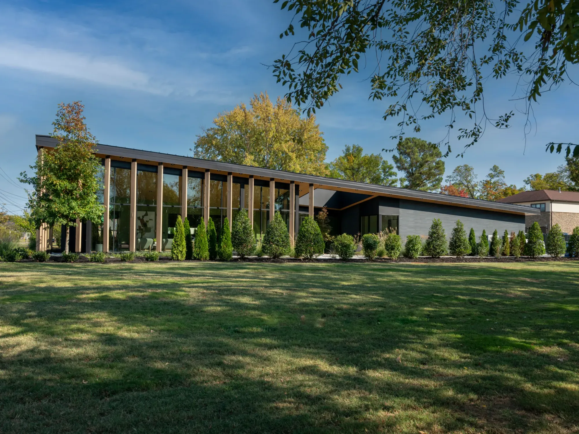 Tall, glassy, and those vertical wood slats are doing a lot.