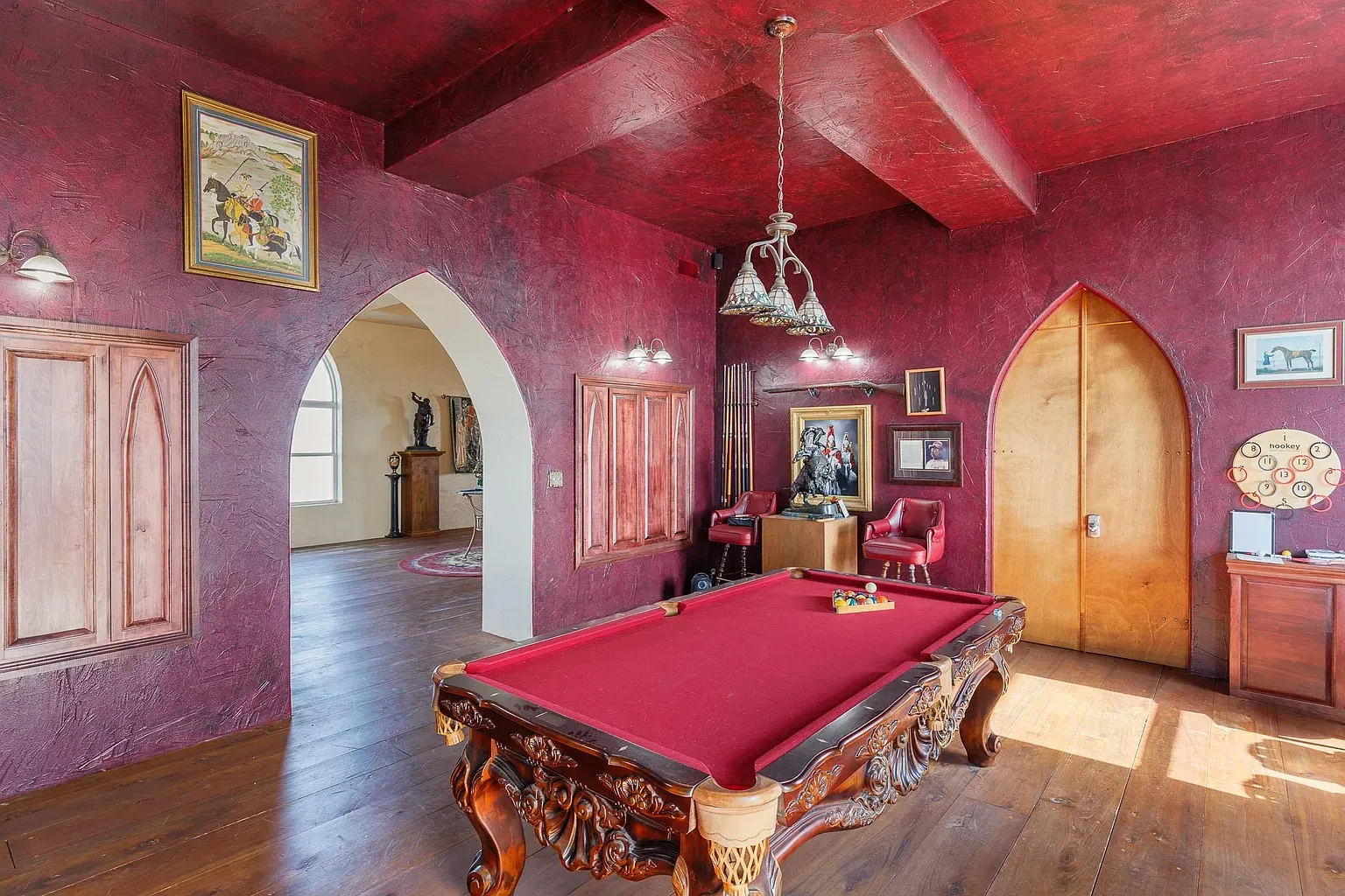 Deep crimson walls with textured plaster. Cozy and dramatic without trying.