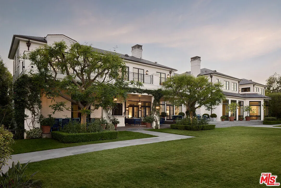Here's the front—crisp white, huge windows. Modern but still inviting.