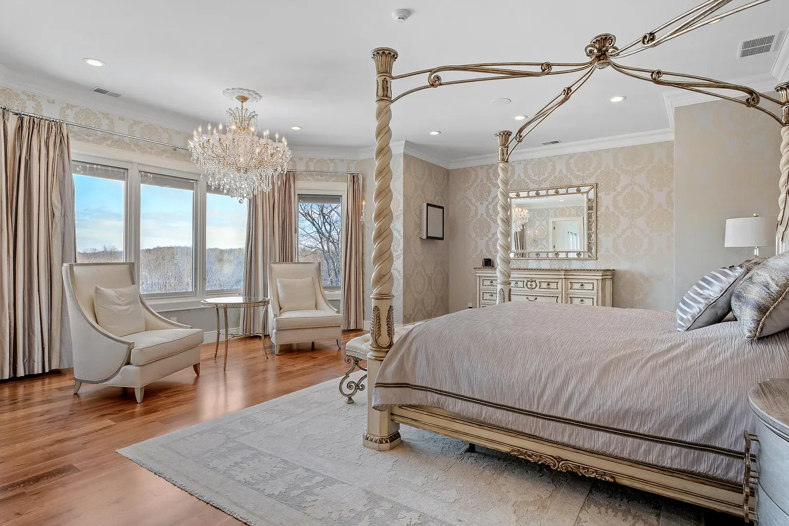 Four-poster centerpiece, creamy and silver everything. Looks a hotel suite upgrade.