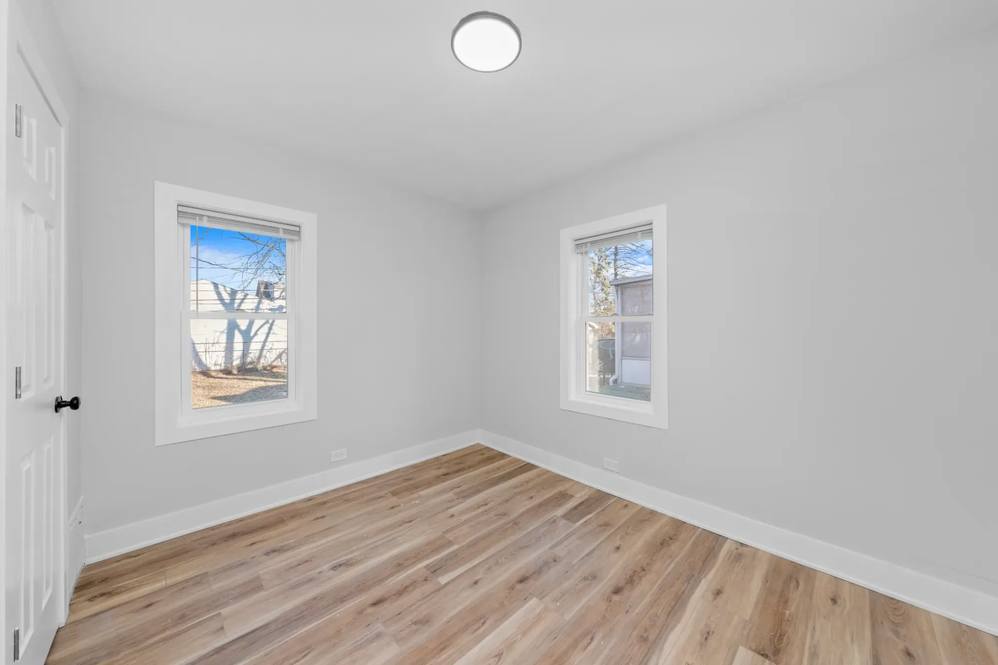 Light gray walls, two different windows. Intentional mismatch? Not sure, but interesting.