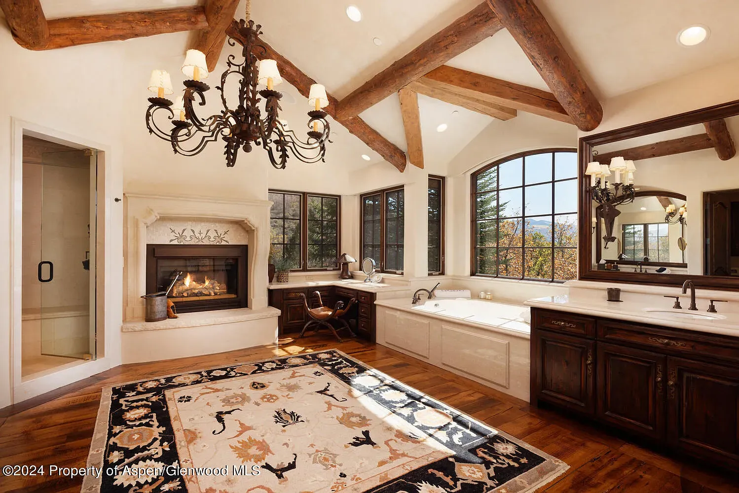 Bathroom with exposed beams and creamy walls. Rustic without losing the spa vibe.