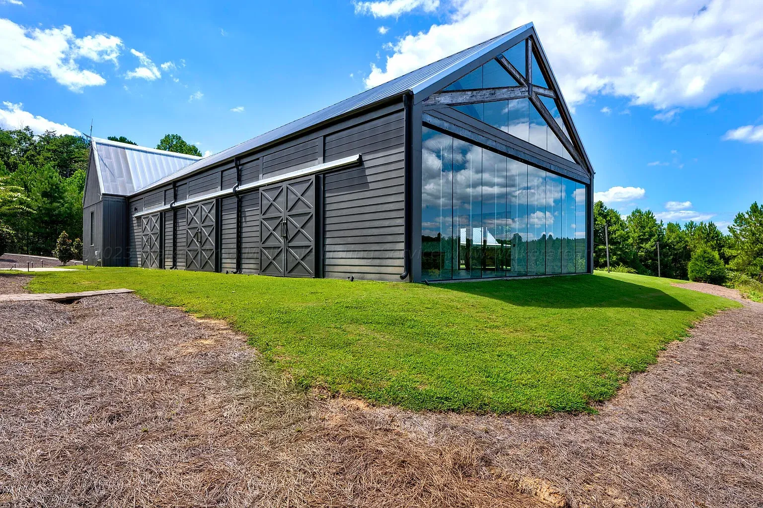 Dark timber barn-meets-modern. Big glass, sharp roofline. Kinda moody and cool.