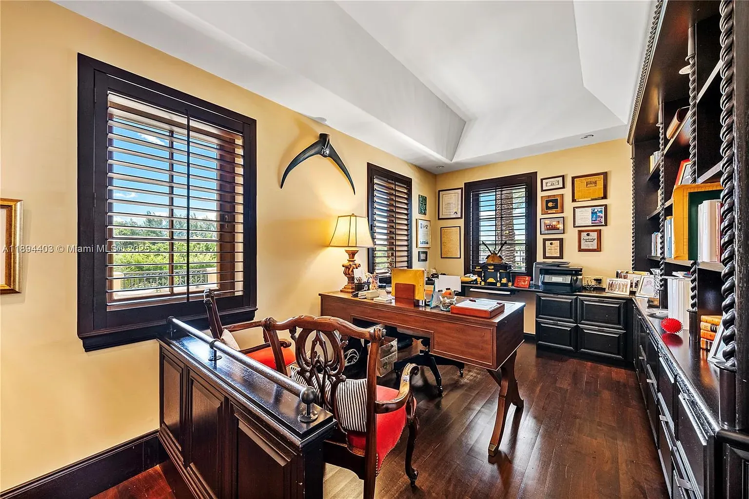 Home office with shutters and golden walls. Productive or nap-inducing?