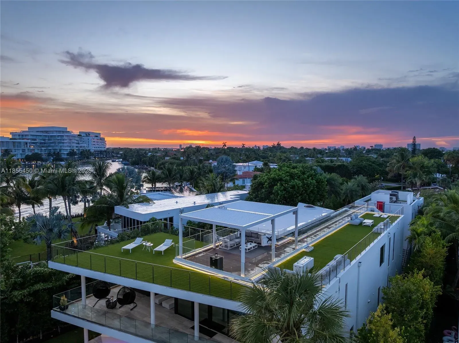 Sunset panorama—glass railing, palms, canals. From this angle, it floats.