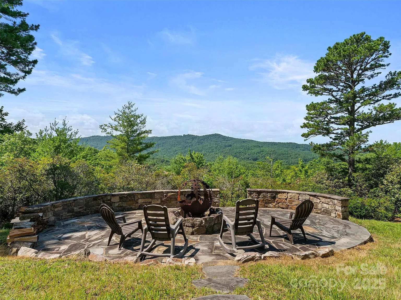 Adirondack circle with mountain backdrop. Fire nights would hit different here.