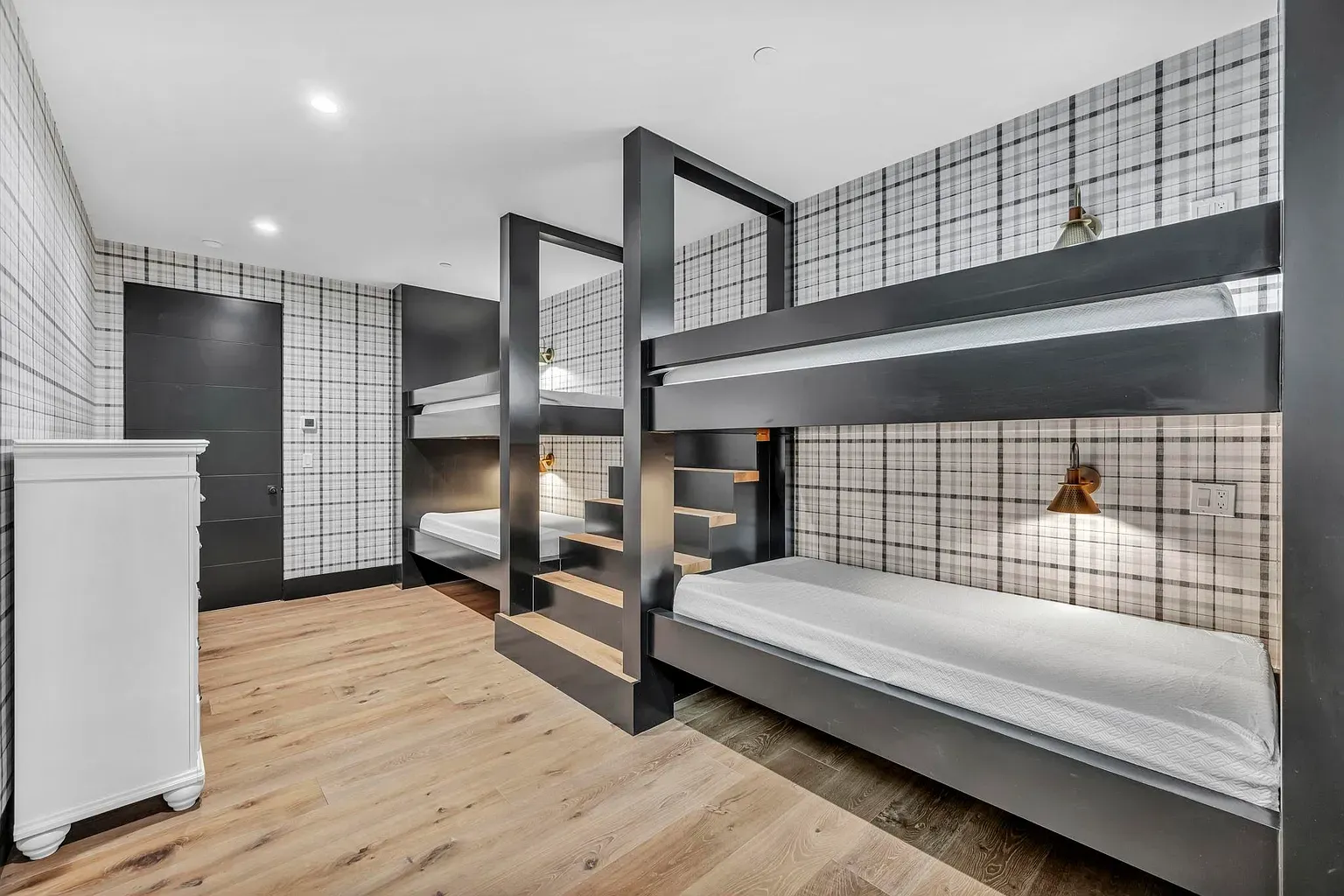 Bunk room goes sleek instead of campy. Built-ins look sturdy.