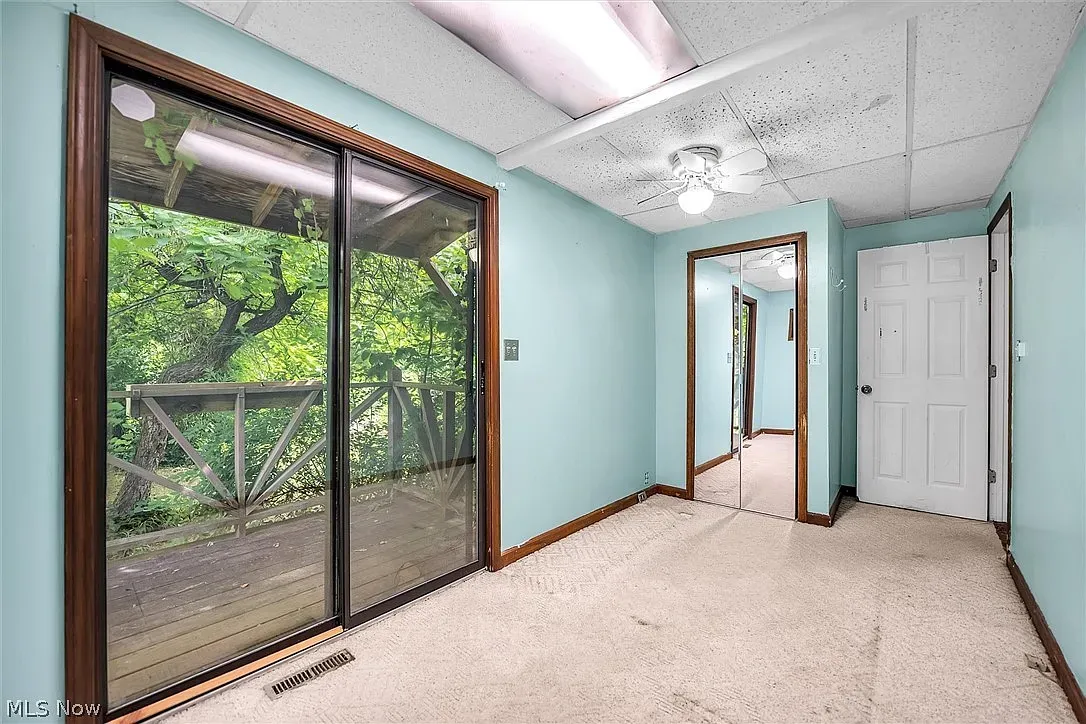 Turquoise walls and a big slider to the trees. Easy indoor-outdoor moment.