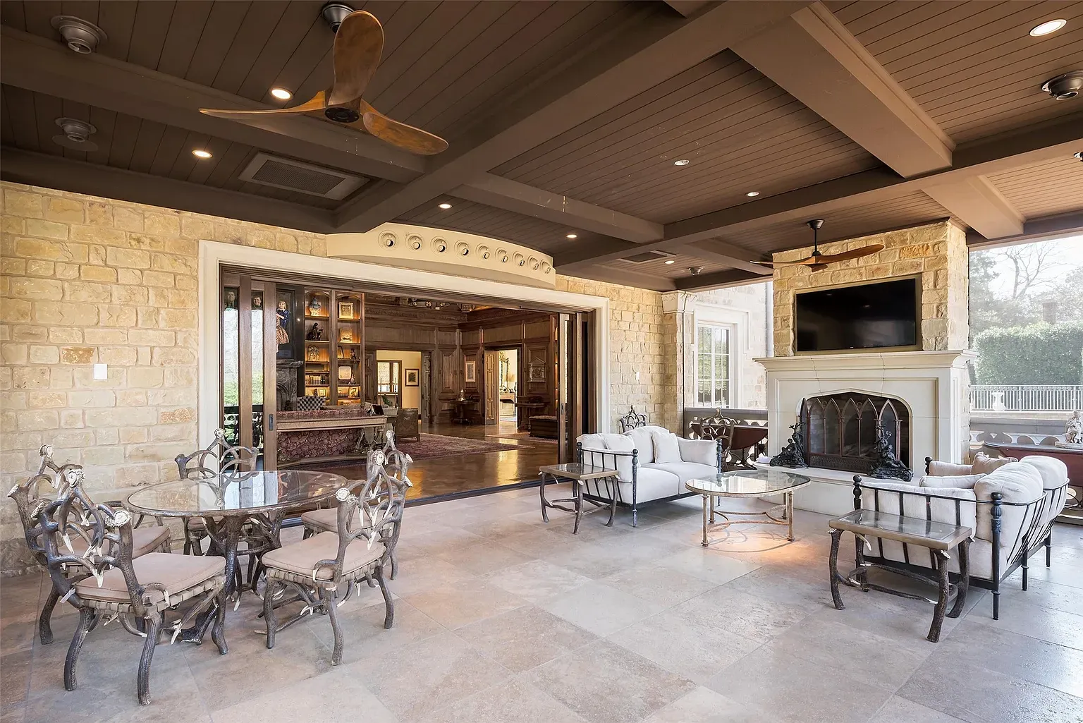 Massive openings to the patio. Limestone everywhere, breezy and calm.