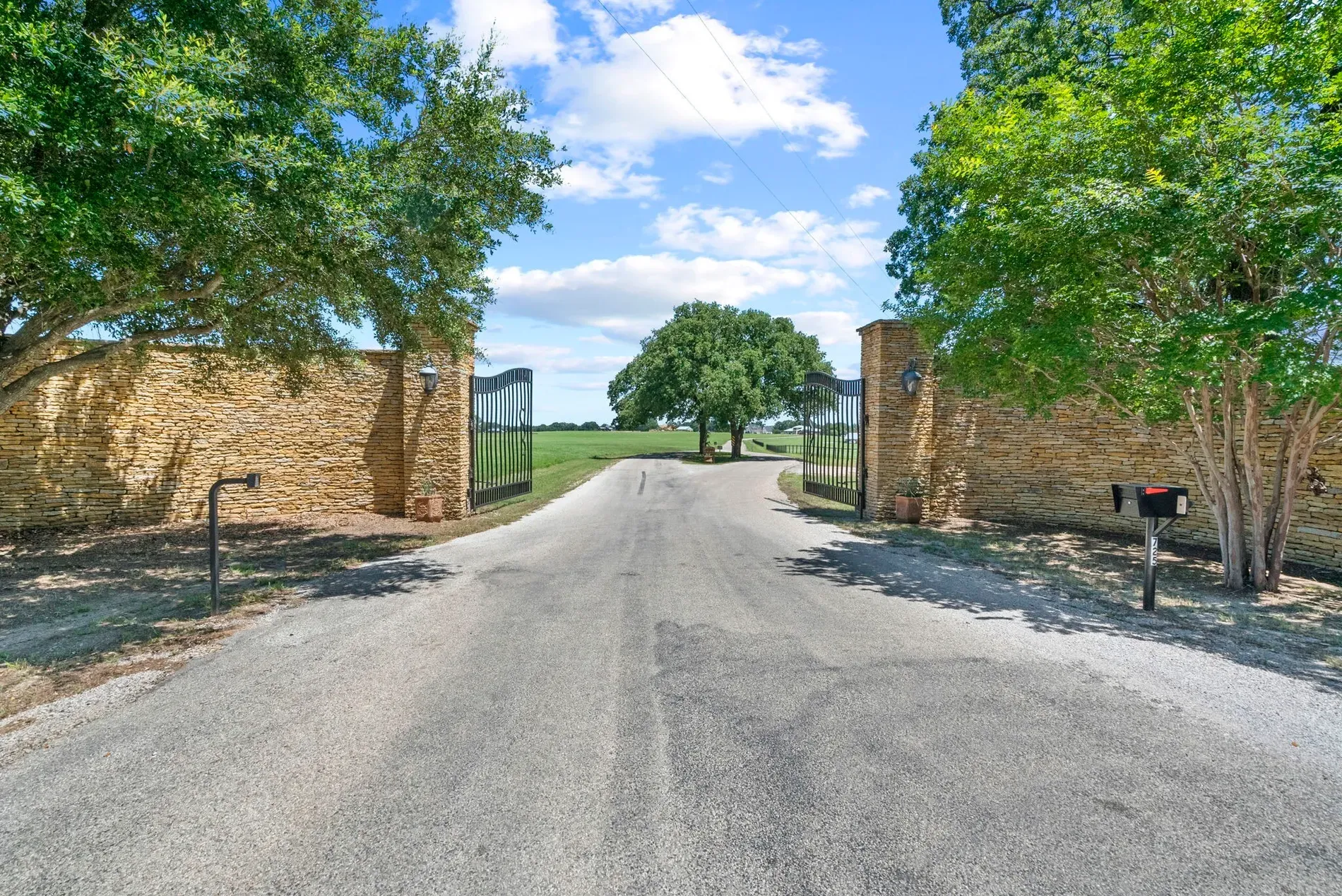 Grand stone gate vibes. Wrought iron and countryside drama right at the entrance.