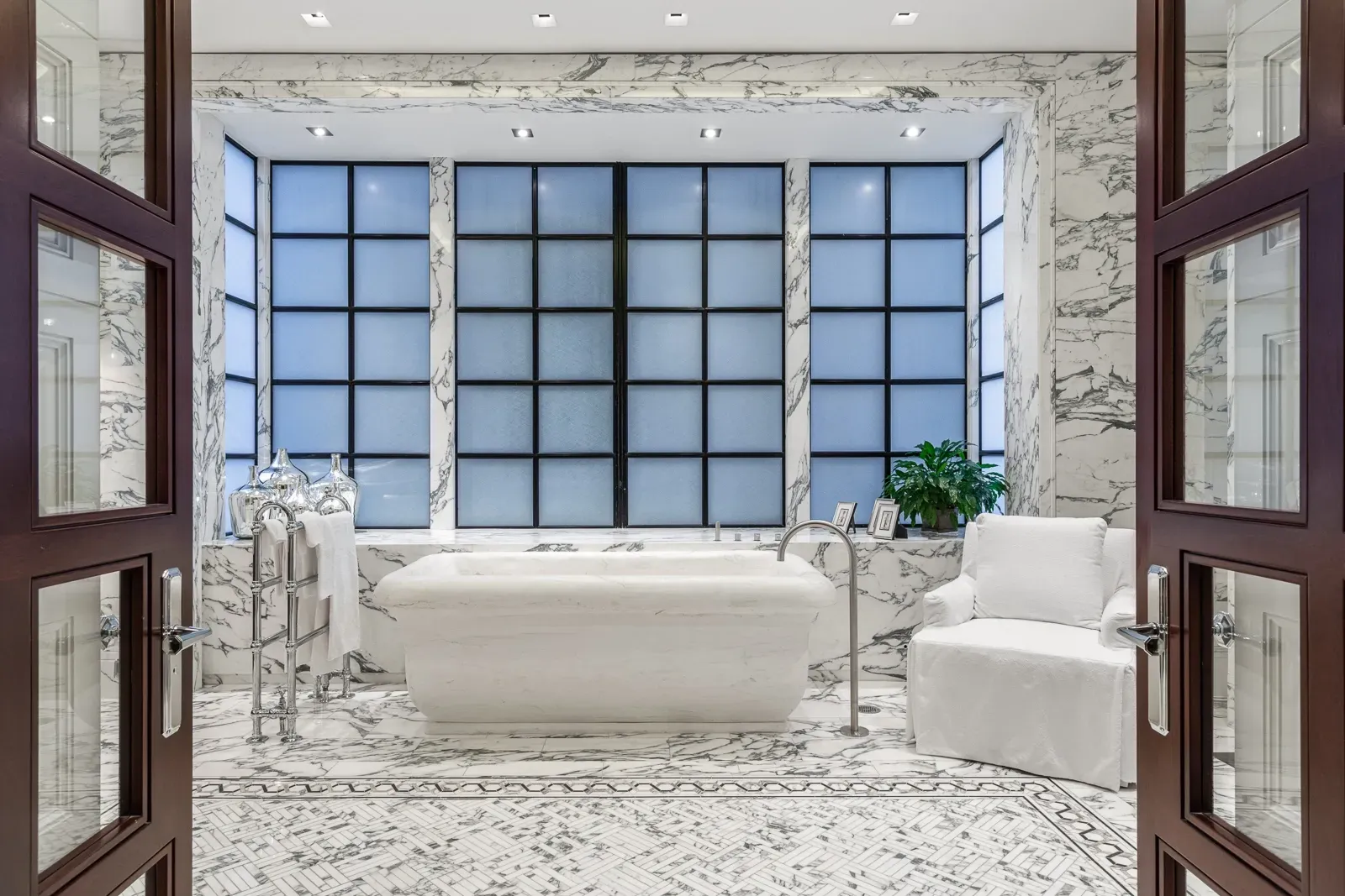 Marble everywhere past those double doors. Glossy, dramatic, almost hotel.