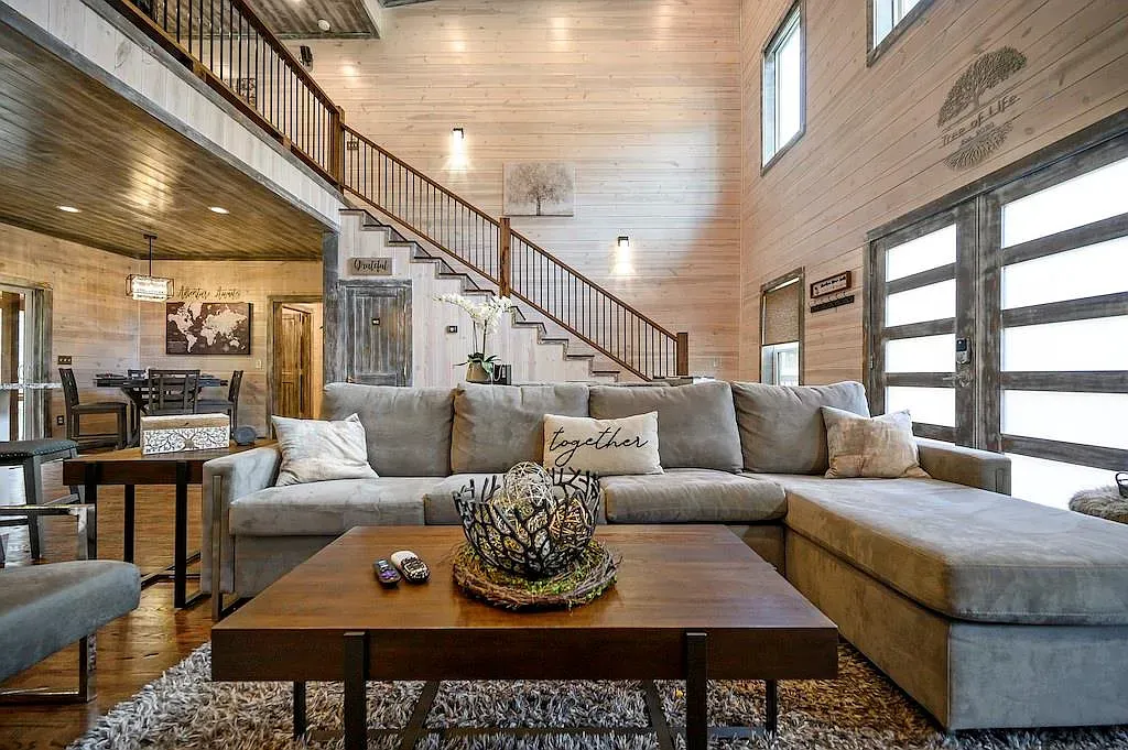 Light wood walls again. Feels airy, with comfy seating pulling it together.