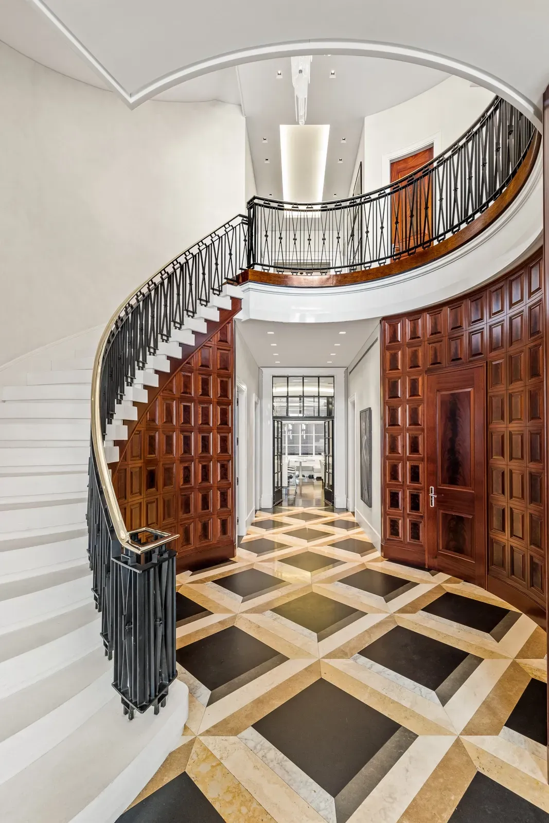 Curved staircase, black iron on white steps. Classic with a modern edge.