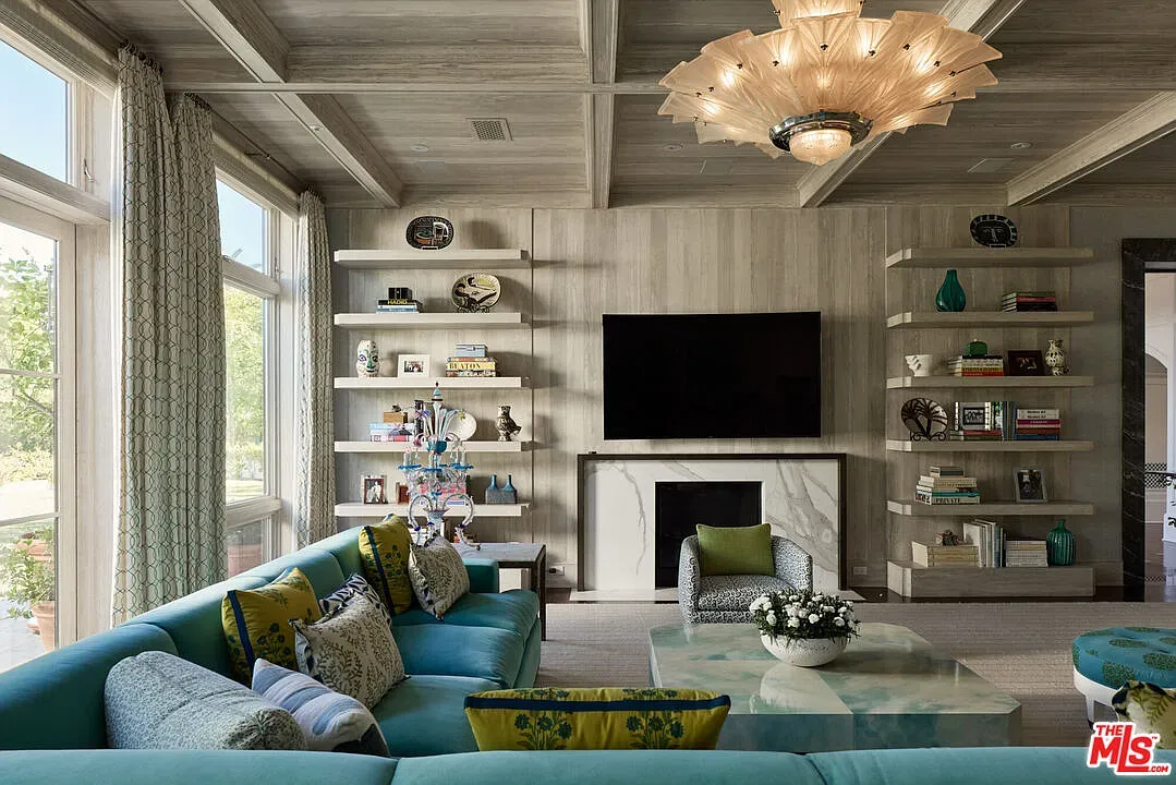 Aqua sectional is loud but fun. Pillows tie in earthy tones.