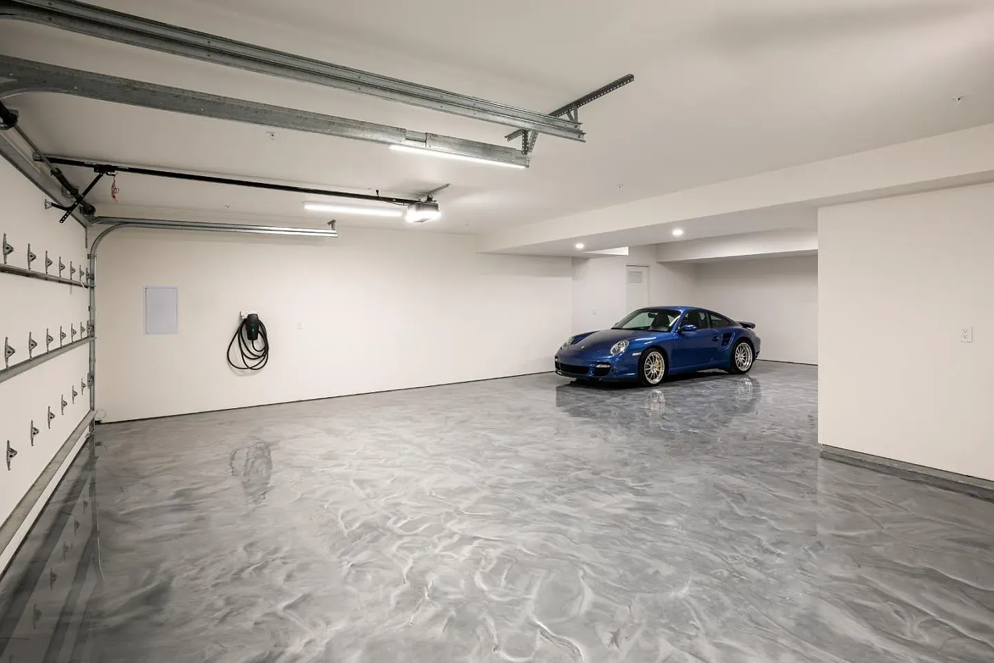Tall, spotless garage. White walls, plenty of room for gear.
