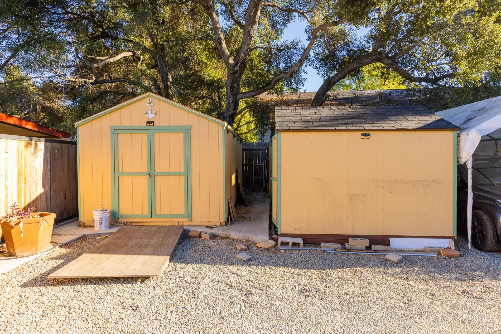Backyard has two little sheds, whimsical vibes but actually useful.