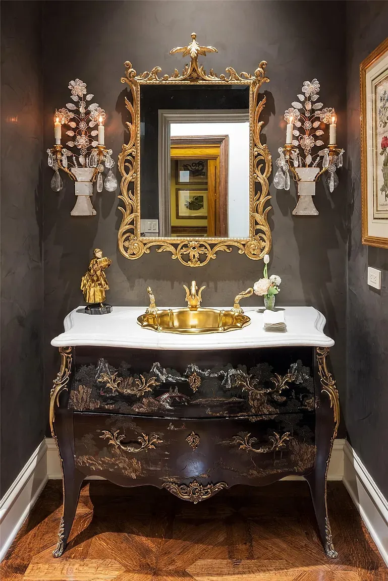 Dark bathroom with a carved vanity stealing the spotlight. Moody spa feel.