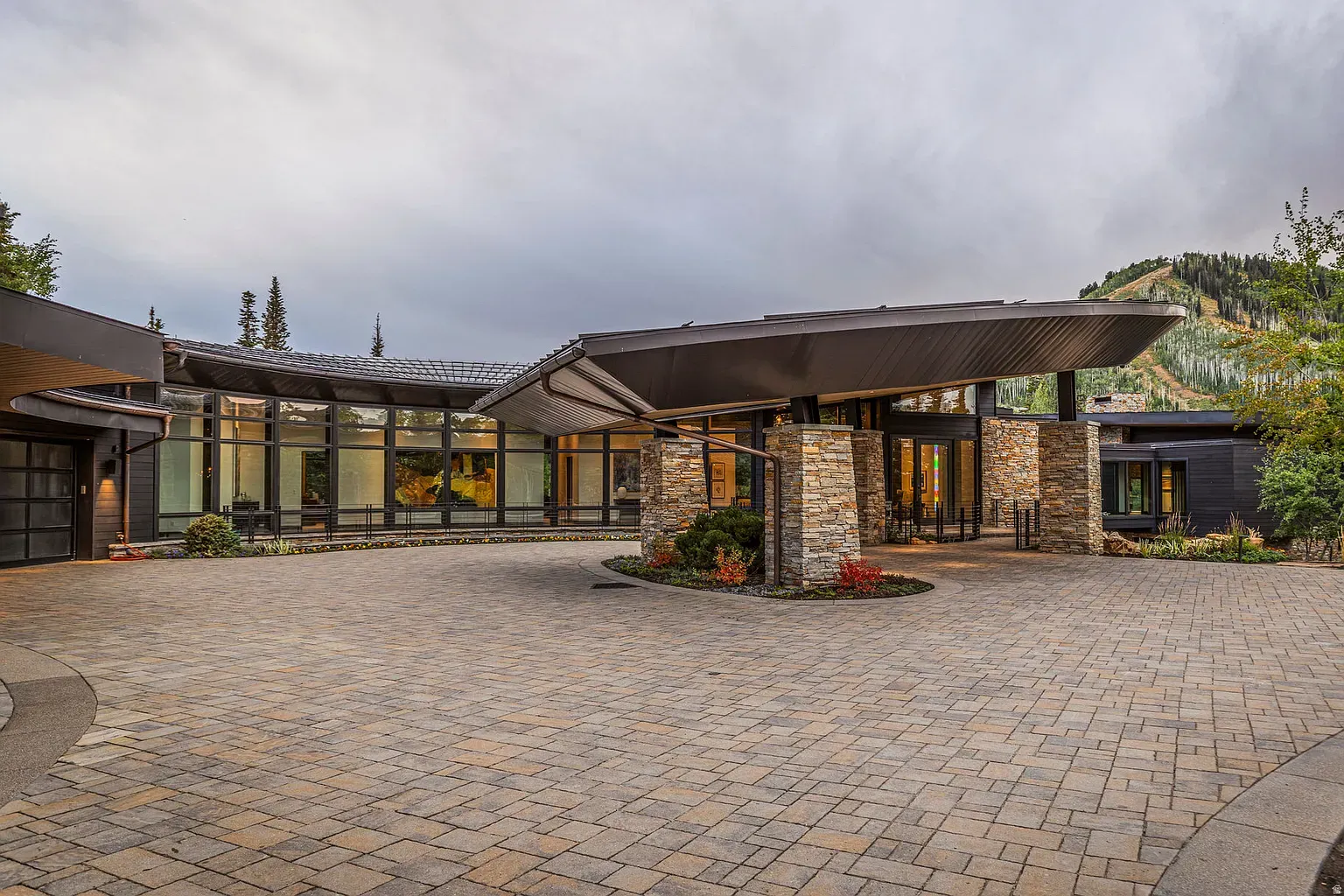 Pull-up zone under that dramatic roof. Feels arriving at a museum.