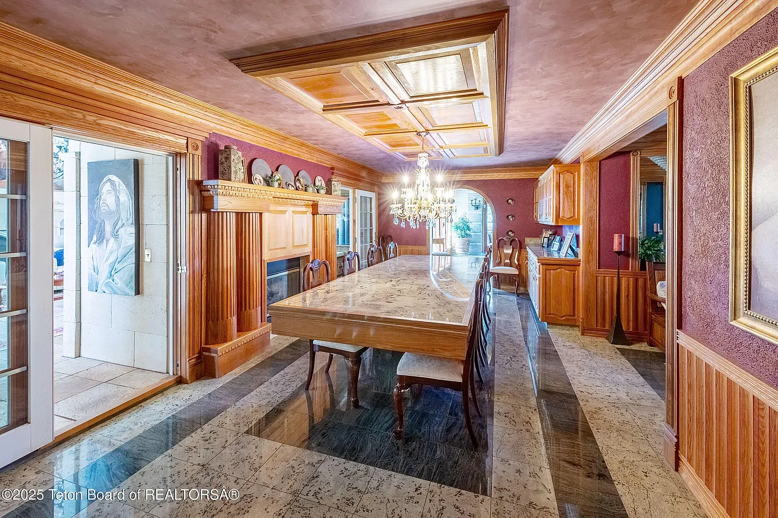 Formal dining with dark walls and crown molding. Pretty sure there’s a big chandelier.