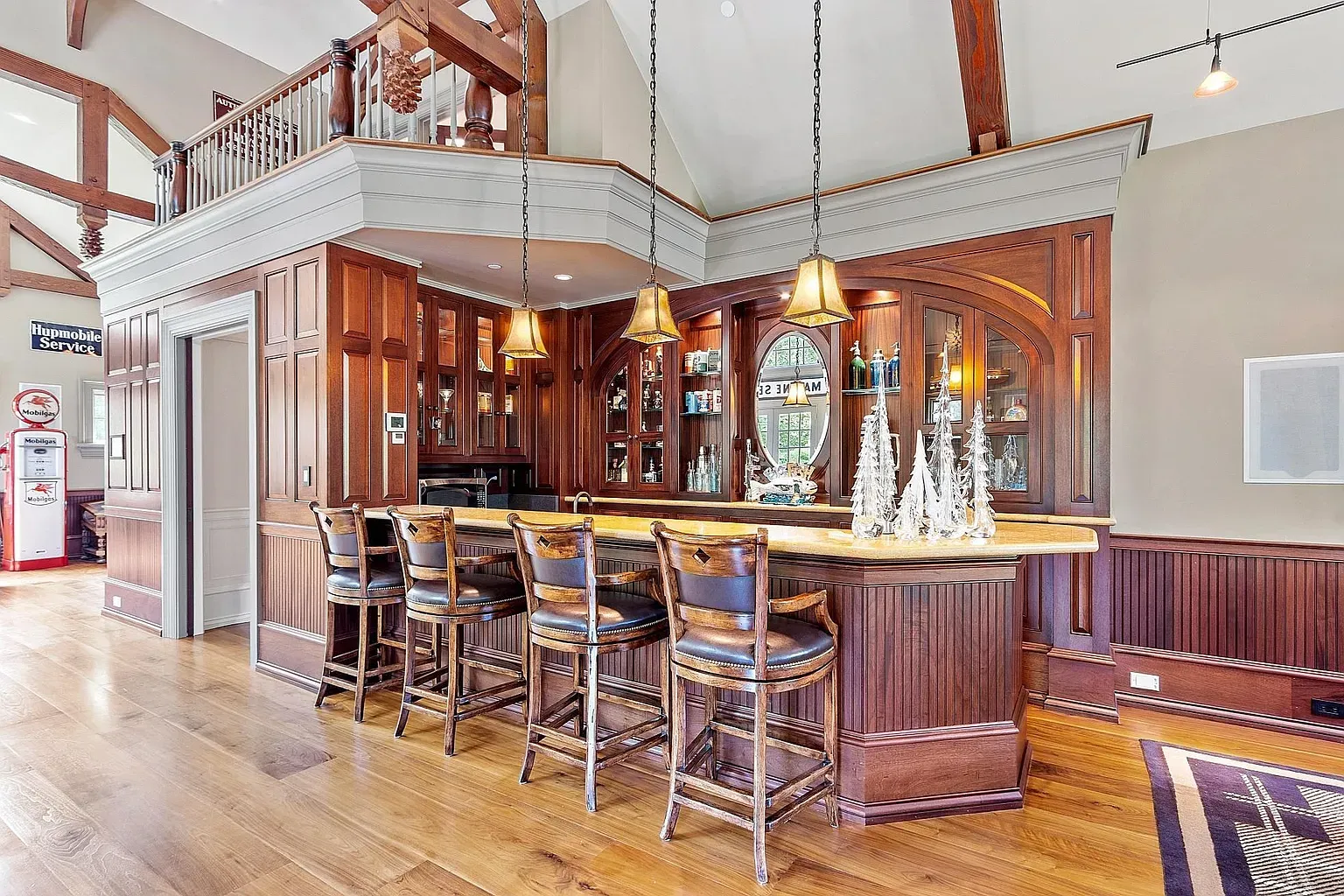 Home bar goals. dark wood, shiny counter, plenty of stools.