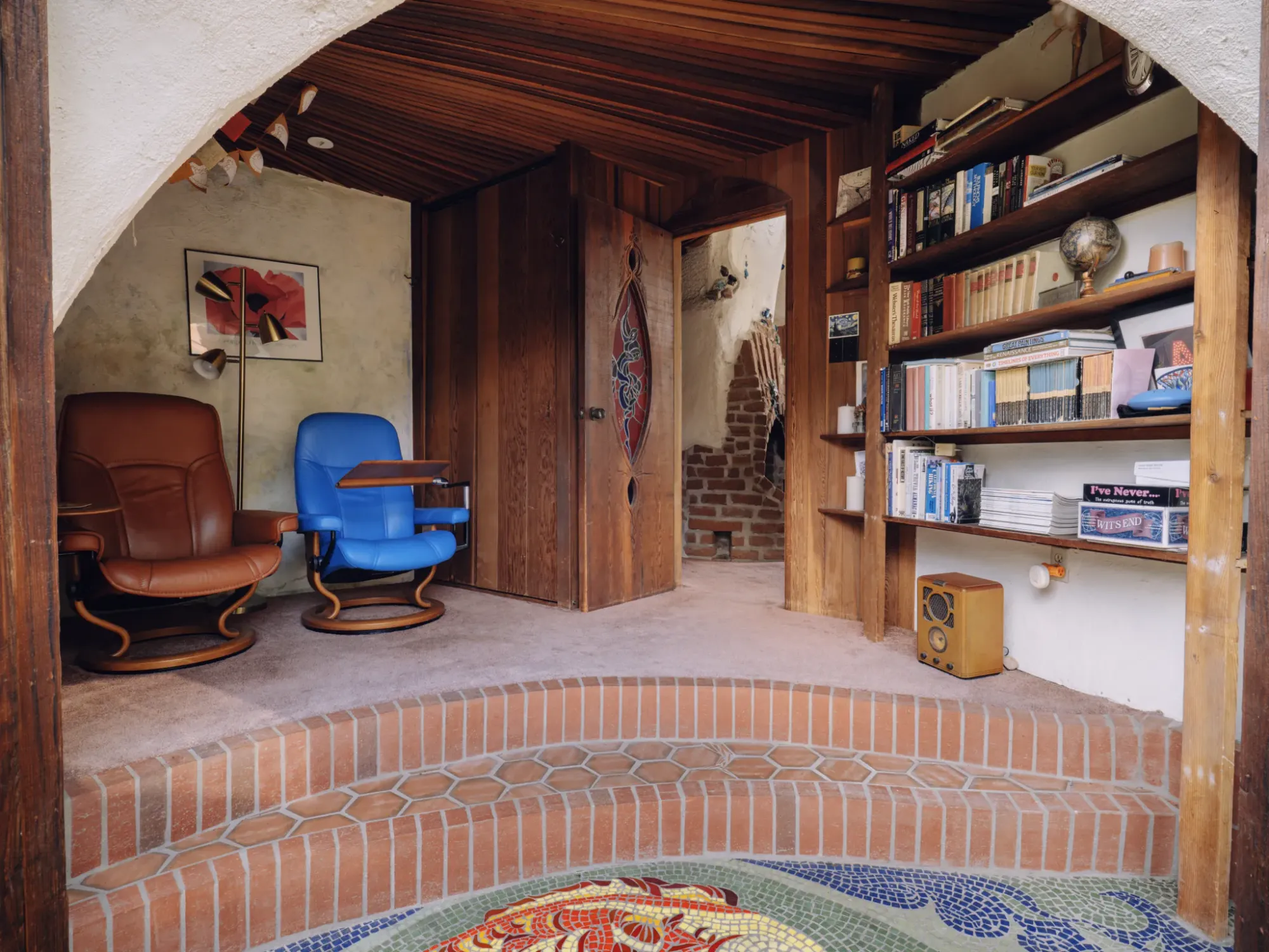 Ceiling steals it—arched planks and beams make the room feel hugged.