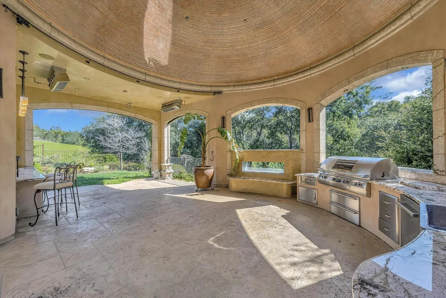 Another outdoor kitchen, but with those big arches framing the view. Fancy picnic zone.