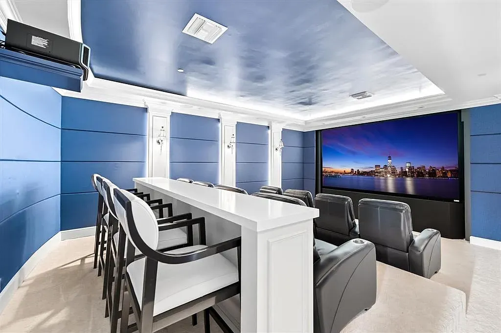 Deep navy theater, plush seats. Yes to popcorn, no to outside world.