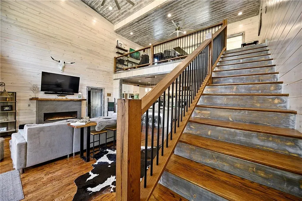 Open living with bleached wood walls and those rich floors. Cozy-modern mashup.