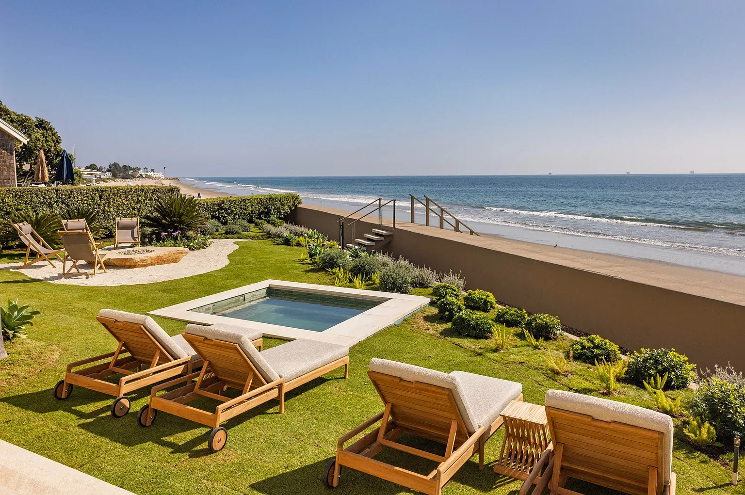 That lawn runs straight to the water. Barefoot commute approved.