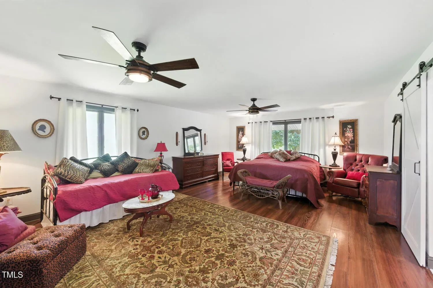 Calm bedroom. hardwood, plush rug, big bed. Hotel vibes without the fee.