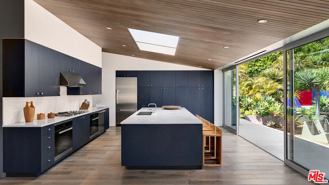 Navy cabinets with marble waterfall island. Yep, this is the cooking flex shot.