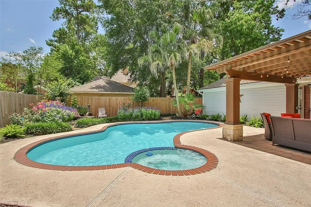 Another angle on the pool—turquoise water, brick edge, greenery doing its thing.